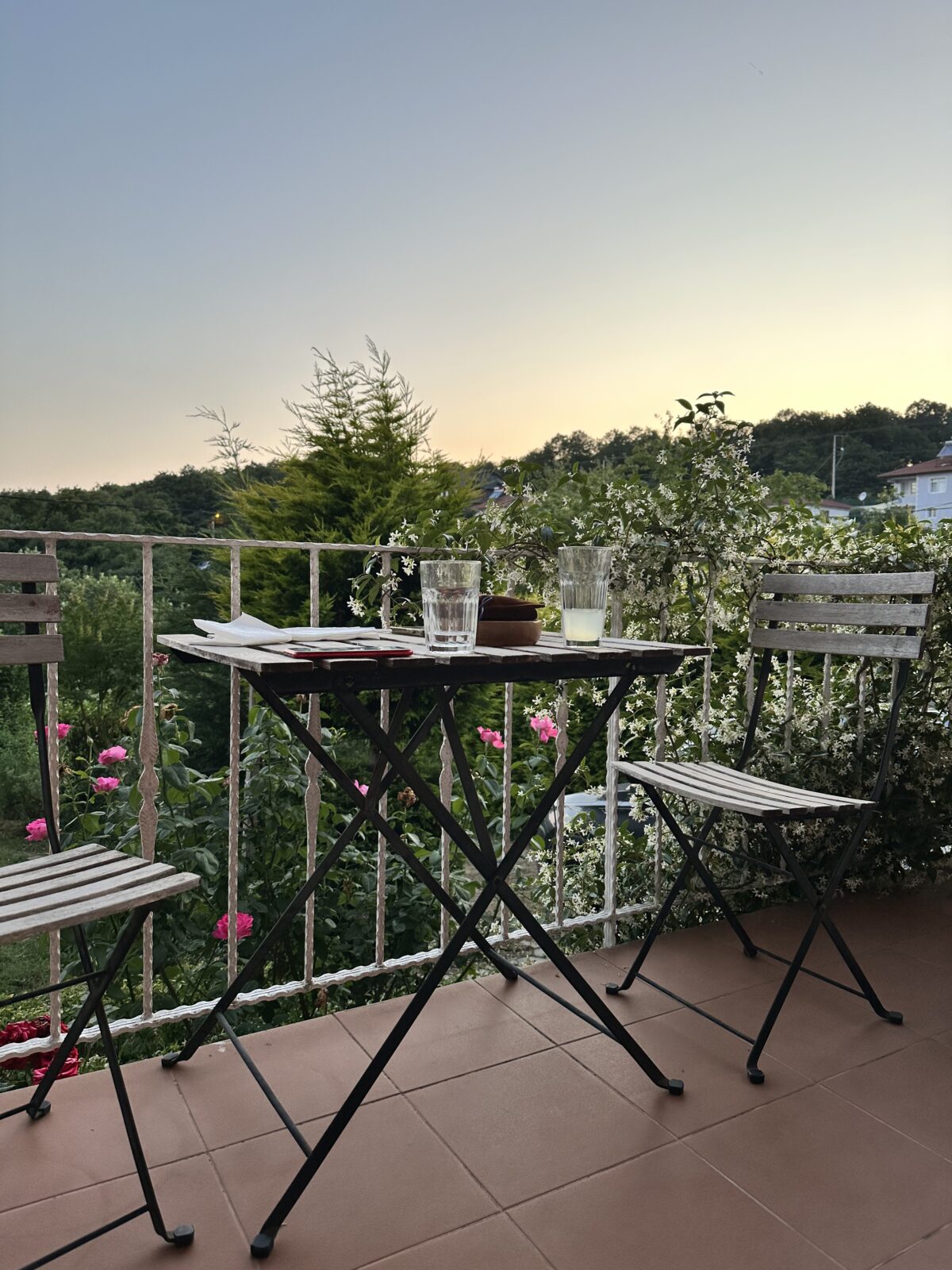 Snapshot of a table and chairs with drinks and journal pages