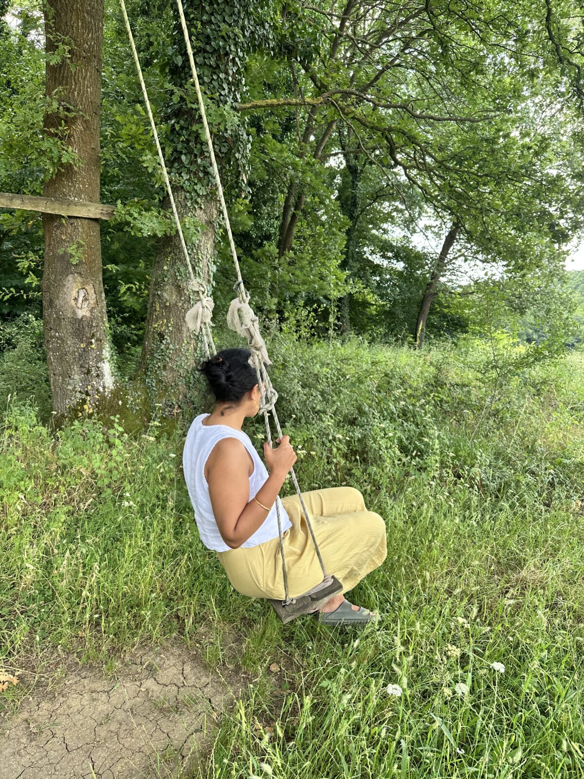 Woman on swing in relaxing nature setting